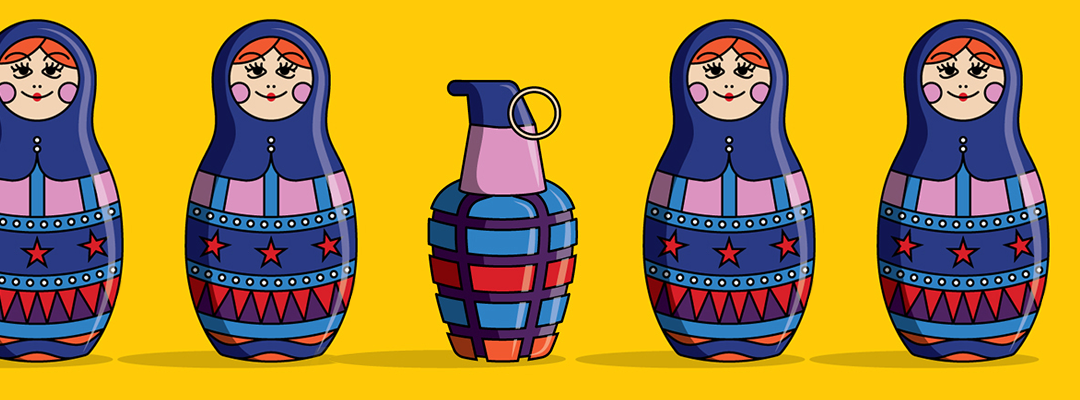 A group of cheerful Russian nesting dolls with a grenade placed beside them.